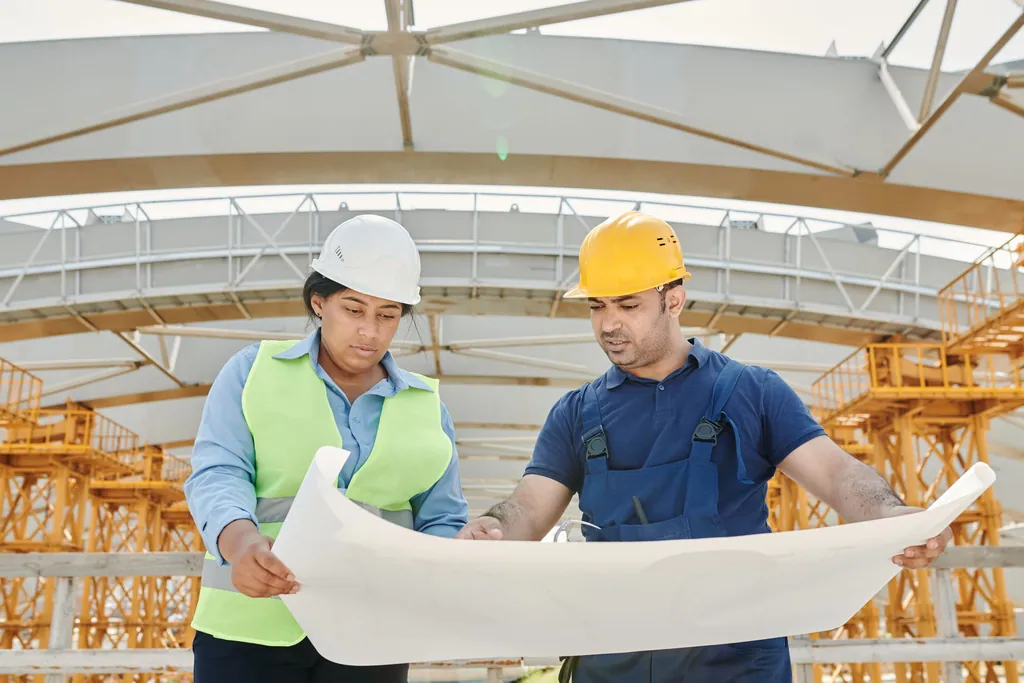 Two people reading a drawing on a construction site
