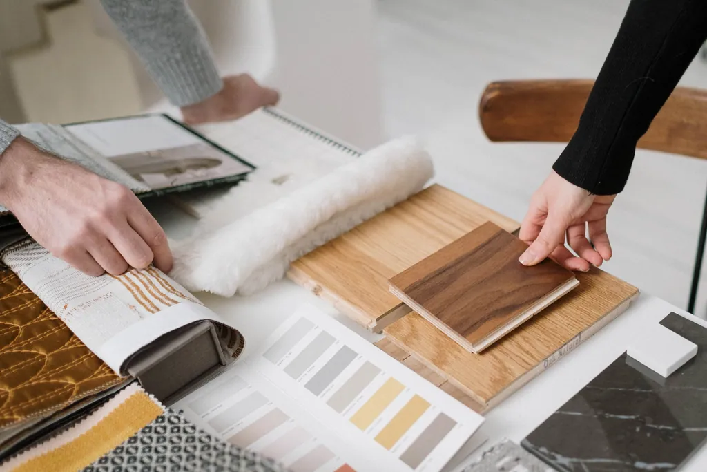 Hands choosing timber, stone and fabric samples